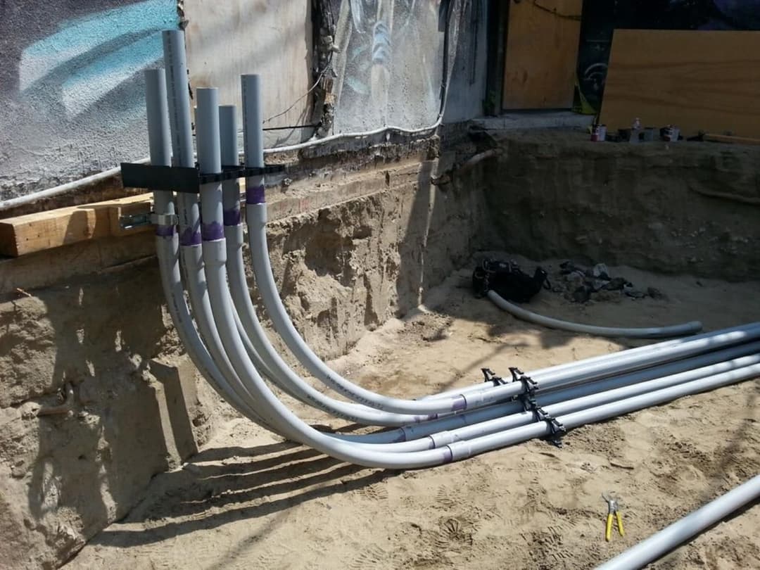PVC pipes installed in a construction site, ready for electrical or plumbing connections.