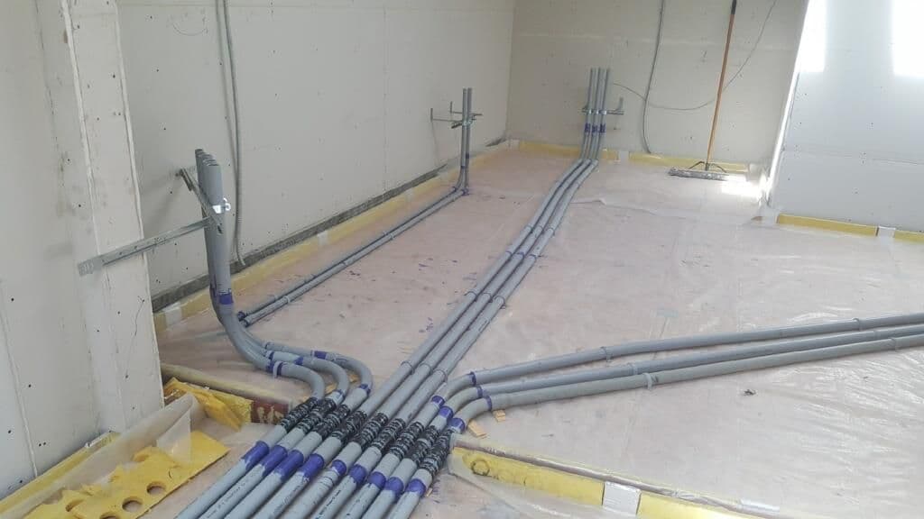 PVC pipes laid out in a construction area, ready for plumbing installation.