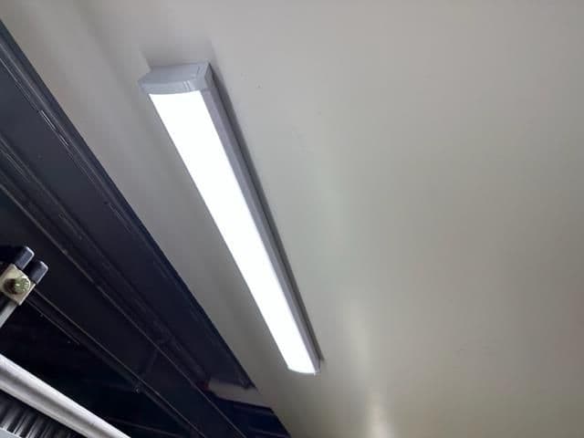 LED ceiling light fixture illuminating a modern indoor space.